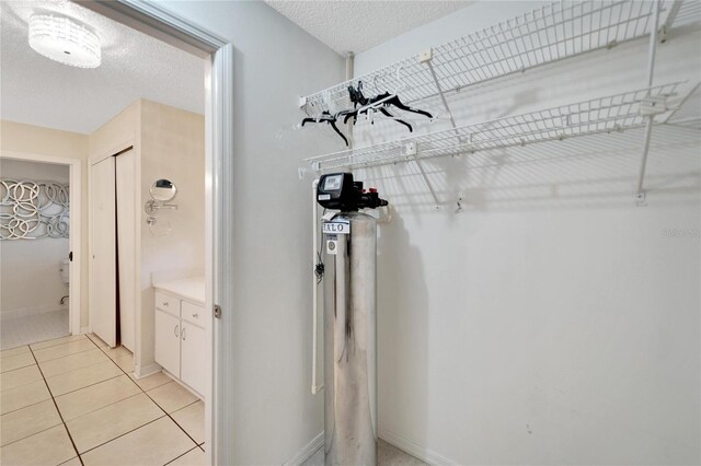 spacious closet featuring light tile patterned floors