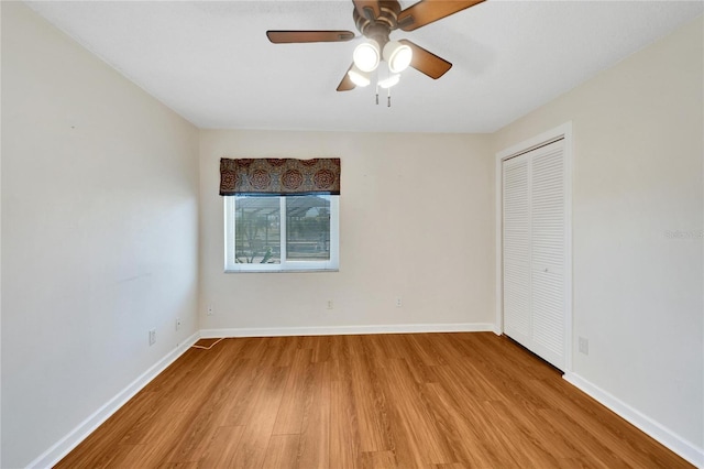 unfurnished room with ceiling fan and light hardwood / wood-style flooring