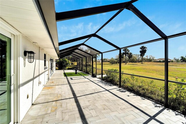 view of patio featuring glass enclosure