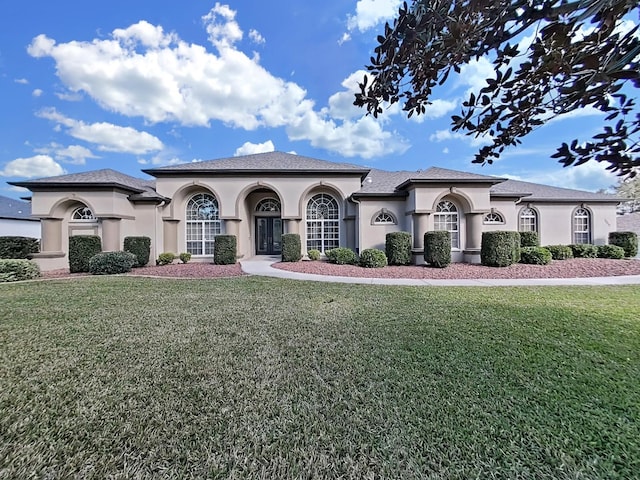 mediterranean / spanish house featuring a front lawn