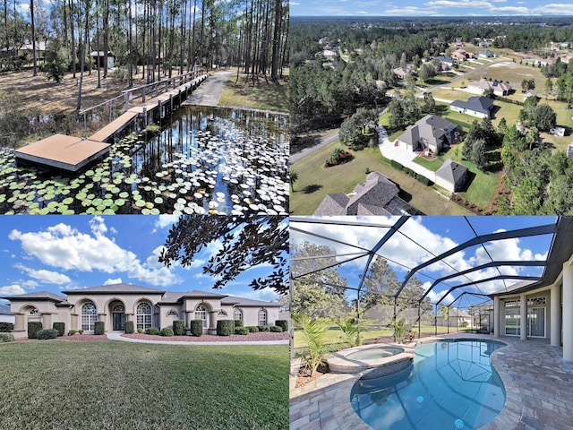 view of pool featuring a yard, a lanai, a water view, and an in ground hot tub