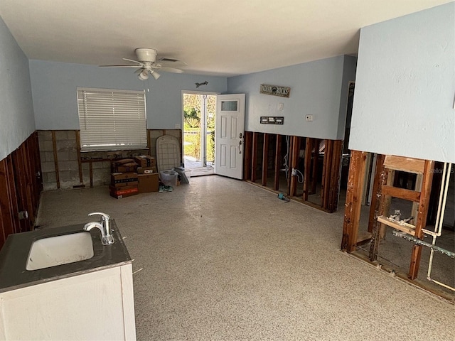 interior space featuring ceiling fan and sink