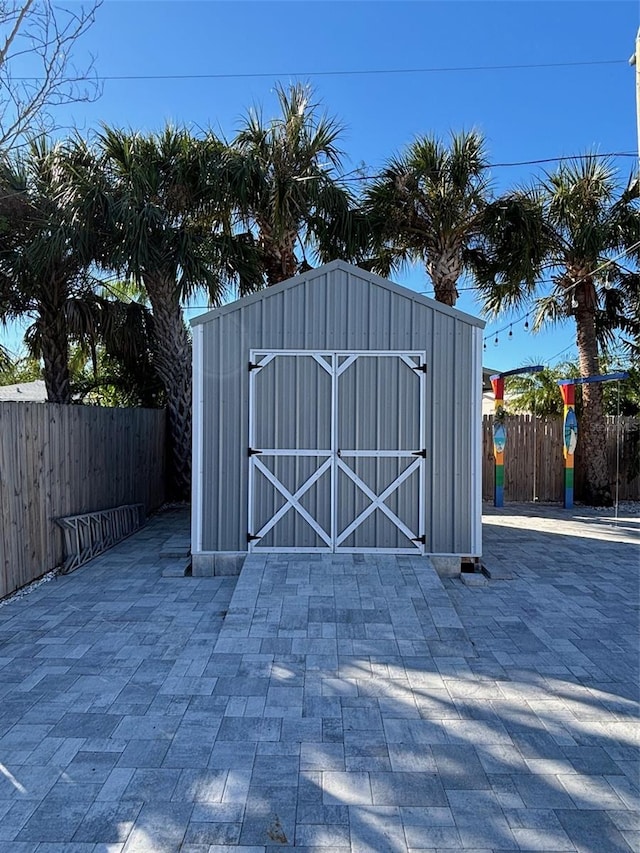 view of gate featuring a storage shed