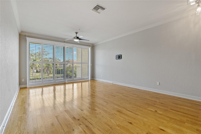 empty room featuring light hardwood / wood-style floors, ceiling fan, and ornamental molding