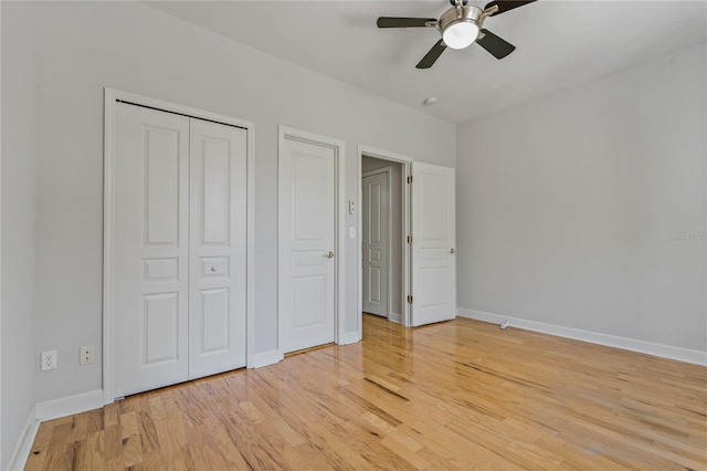 unfurnished bedroom with a closet, hardwood / wood-style flooring, and ceiling fan