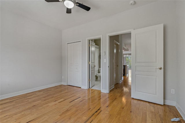 spare room with ceiling fan and light wood-type flooring