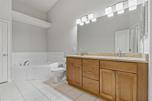 bathroom featuring tile patterned flooring, vanity, toilet, and tiled tub