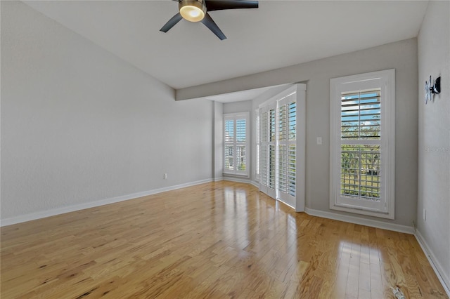 empty room with light wood-type flooring, ceiling fan, and a healthy amount of sunlight