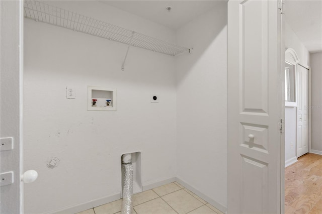 laundry area featuring electric dryer hookup, hookup for a washing machine, and light tile patterned floors