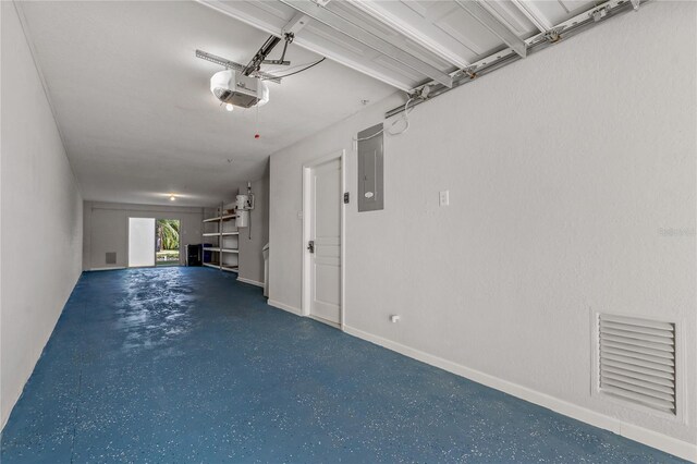 garage featuring electric panel and a garage door opener