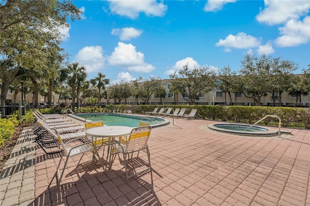 view of swimming pool with a community hot tub and a patio