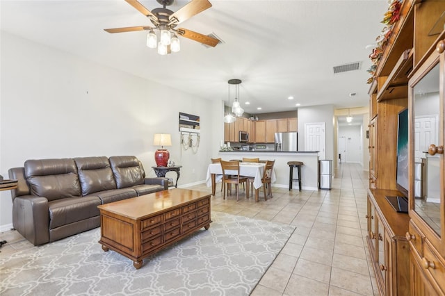 living room with ceiling fan and light tile patterned floors