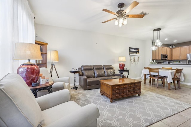 living room featuring ceiling fan and light tile patterned floors