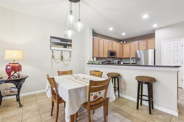 tiled dining room with sink