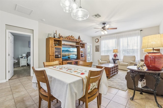 tiled dining area featuring ceiling fan