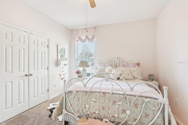 carpeted bedroom featuring a closet and ceiling fan