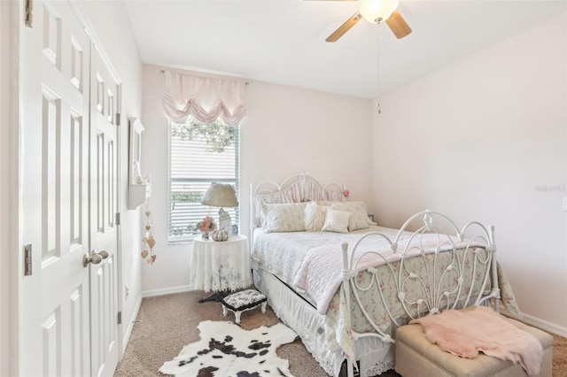 carpeted bedroom with ceiling fan and a closet