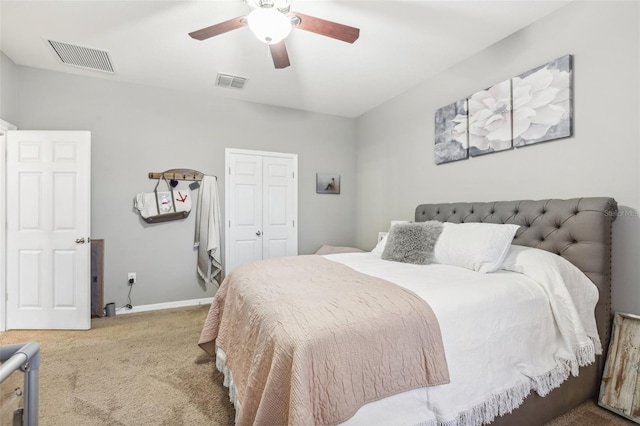 carpeted bedroom featuring ceiling fan and a closet