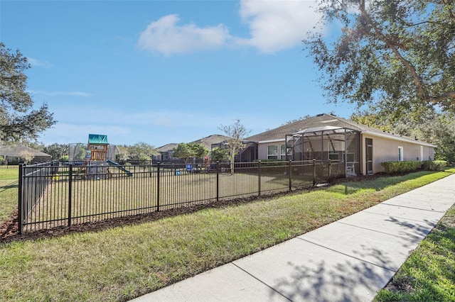 view of yard featuring a playground and a lanai