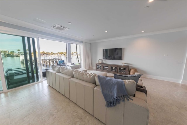 living room featuring a water view and crown molding