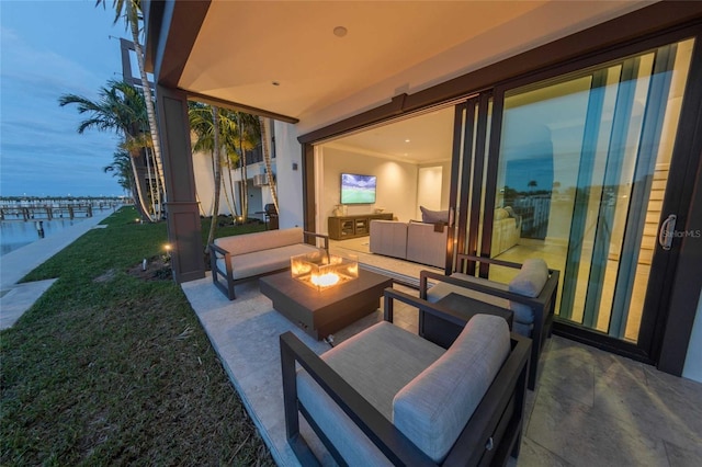 patio terrace at dusk featuring an outdoor living space and a yard