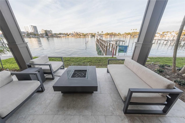 view of patio / terrace with an outdoor living space with a fire pit and a water view