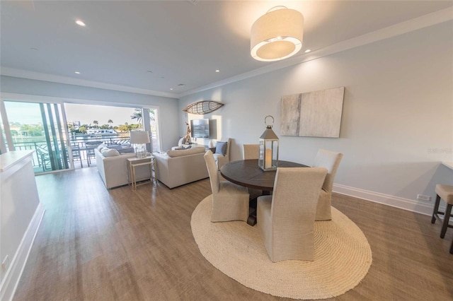 dining room featuring wood-type flooring and crown molding