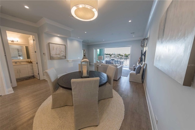 dining area with ornamental molding and wood-type flooring