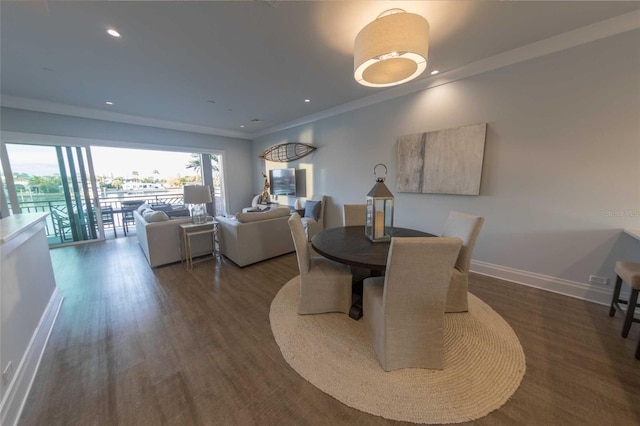 dining space with crown molding and dark hardwood / wood-style floors