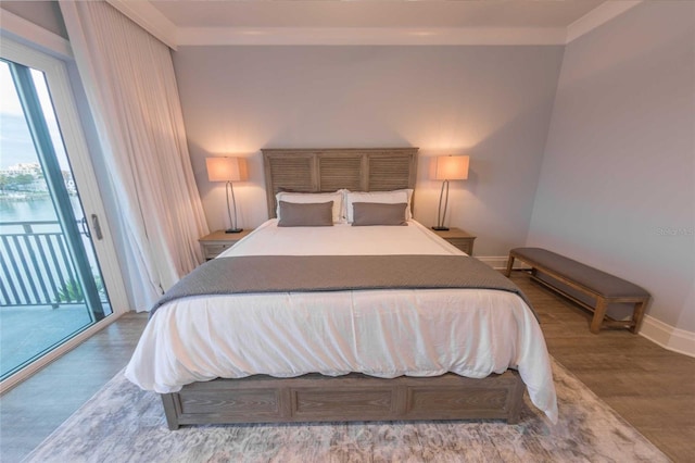 bedroom featuring access to exterior, crown molding, and wood-type flooring