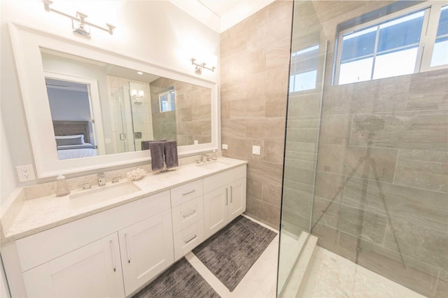 bathroom with vanity and tiled shower