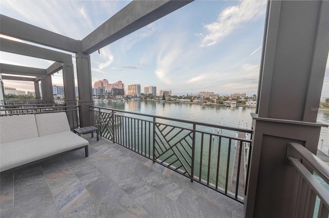 balcony with an outdoor hangout area and a water view