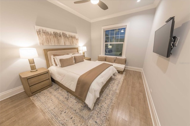 bedroom with ceiling fan, wood-type flooring, and ornamental molding