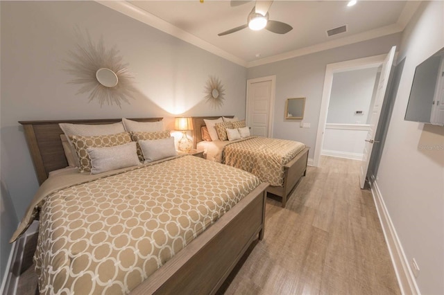 bedroom featuring light wood-type flooring, ceiling fan, and ornamental molding