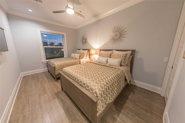 bedroom with ceiling fan, hardwood / wood-style floors, and crown molding