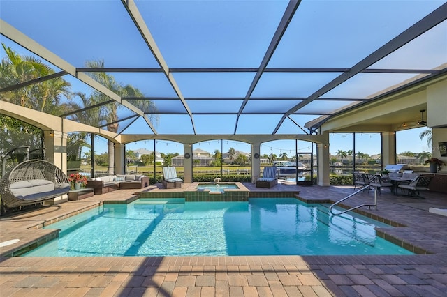 view of swimming pool with a lanai, an outdoor hangout area, an in ground hot tub, and a patio