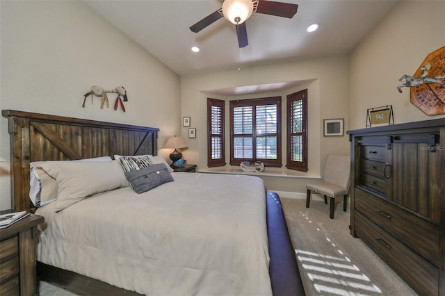 carpeted bedroom with ceiling fan and lofted ceiling