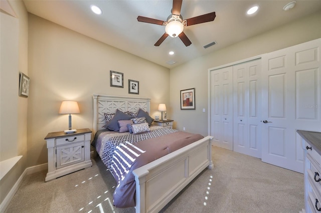 carpeted bedroom with ceiling fan and a closet