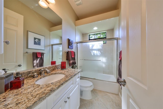 full bathroom featuring toilet, tile patterned flooring, vanity, and shower / bath combination with glass door