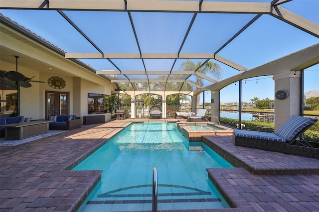 view of swimming pool with a water view, an outdoor living space, a patio, and an in ground hot tub