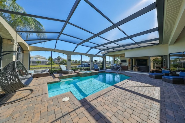 view of swimming pool featuring glass enclosure, outdoor lounge area, a patio area, and an in ground hot tub