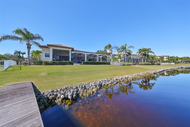 dock area featuring a water view and a lawn