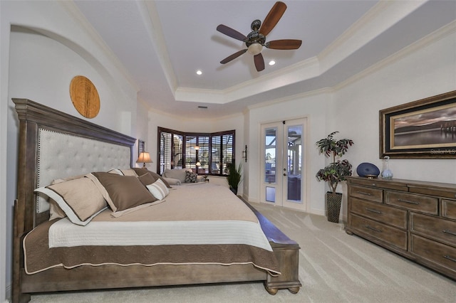 carpeted bedroom featuring access to outside, ceiling fan, french doors, and a raised ceiling