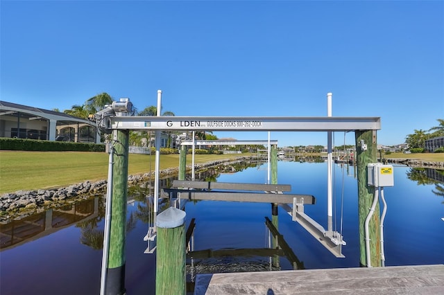 dock area with a water view and a yard