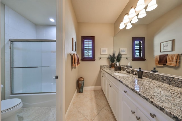 full bathroom with tile patterned flooring, a wealth of natural light, and vanity