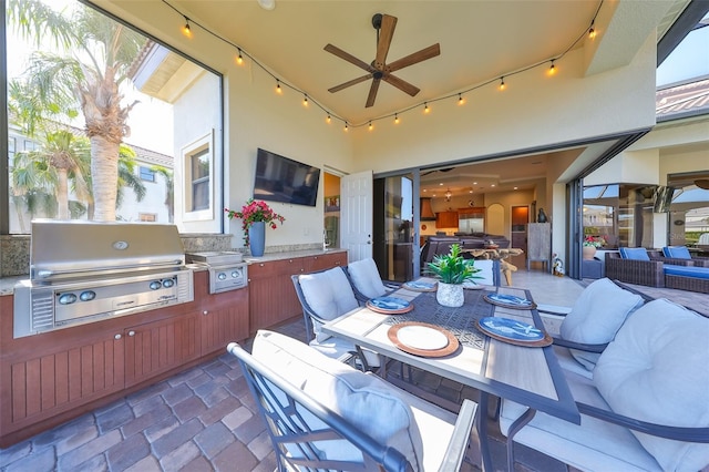 view of patio / terrace with ceiling fan, exterior kitchen, outdoor dining area, and area for grilling