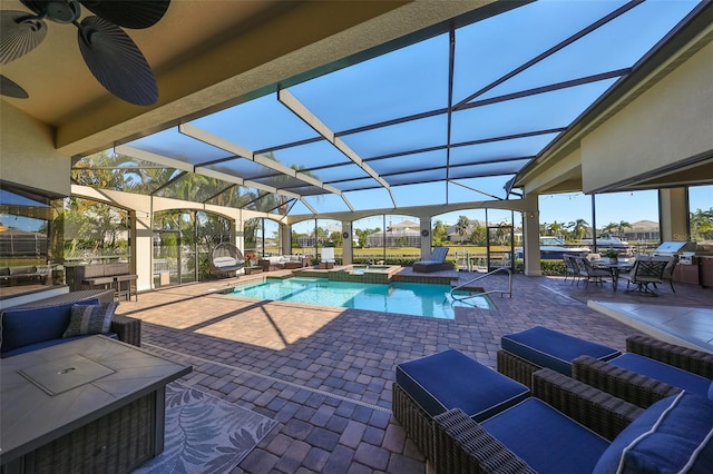 view of pool featuring a pool with connected hot tub, a patio area, a lanai, and an outdoor hangout area