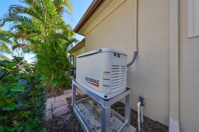 exterior details featuring a power unit and stucco siding