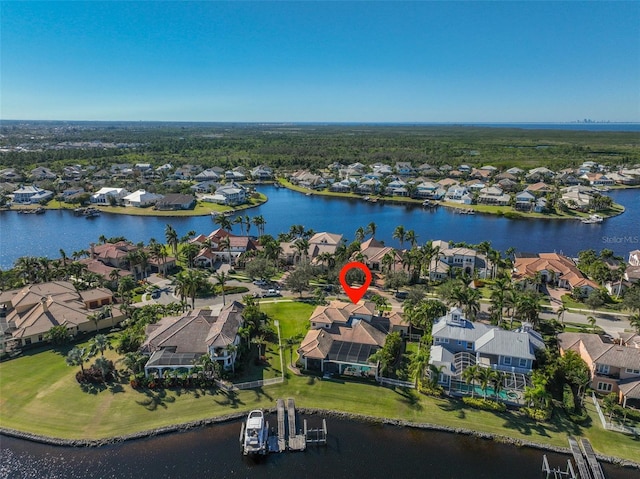 drone / aerial view with a water view and a residential view