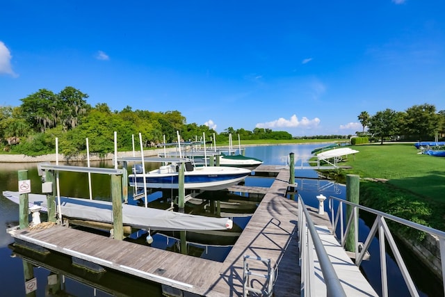 dock area with a water view and boat lift